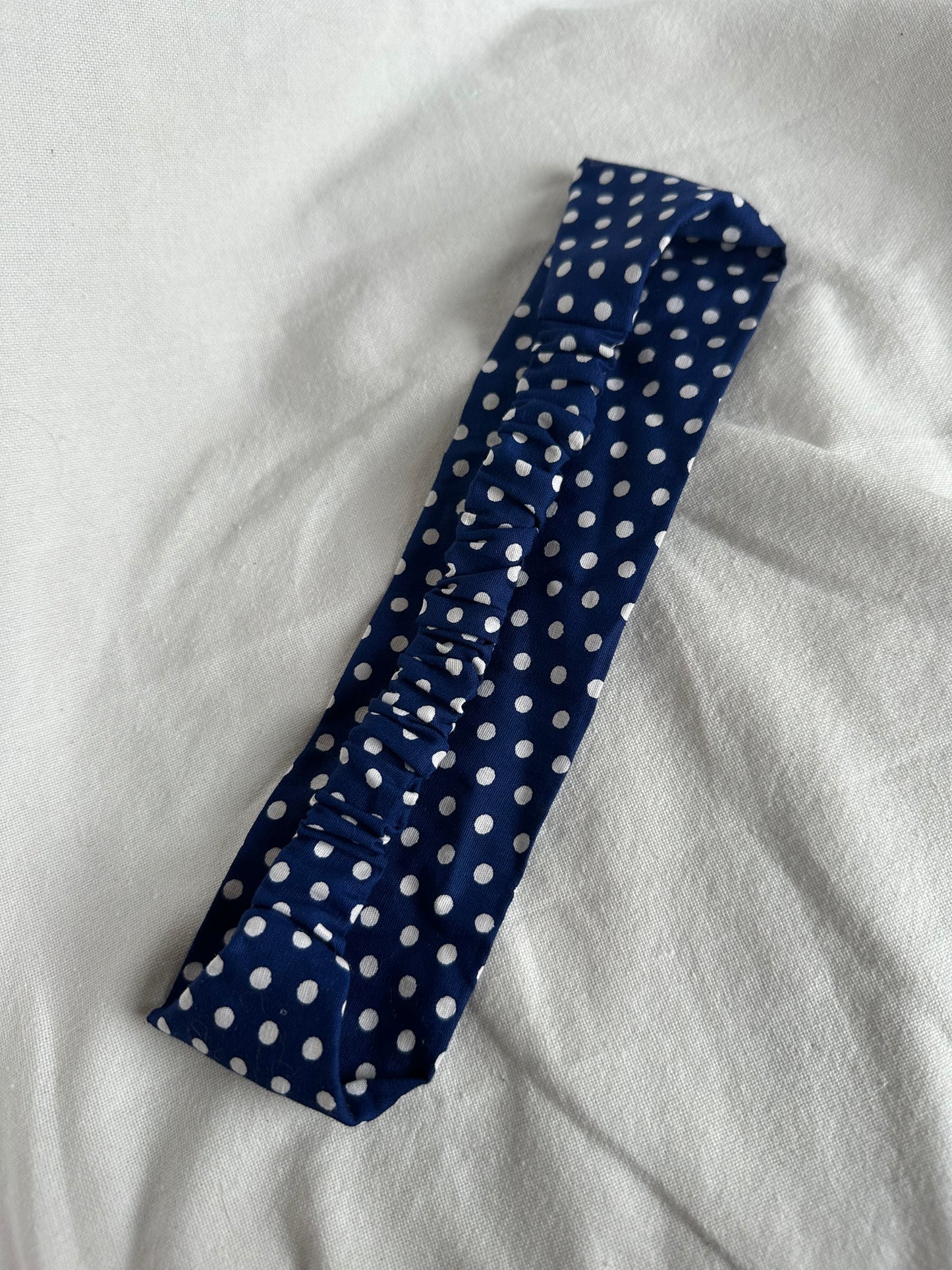 Blue headband with white polka dots